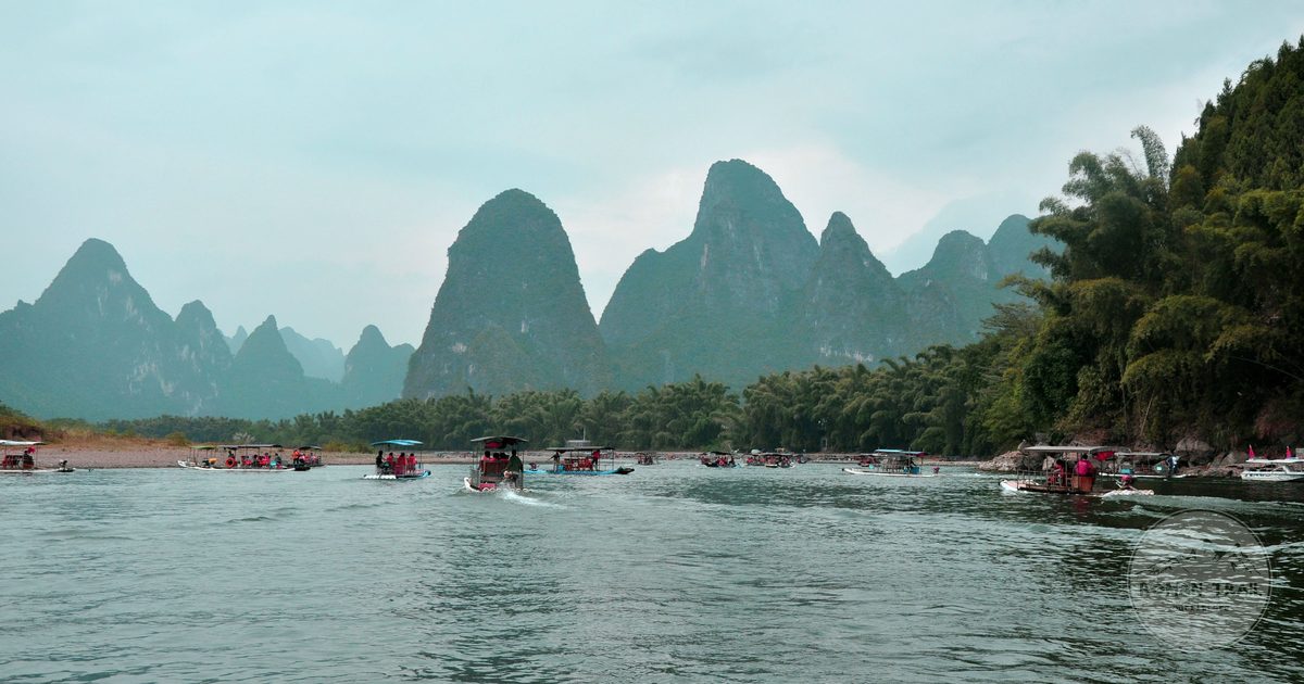 Boats on the Li River below karst hills at Yangshuo, Guangxi, China