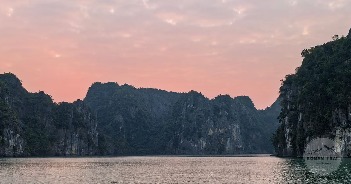 Limestone formations in Ha Long Bay under a sunset sky, Vietnam
