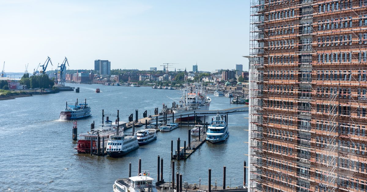 Boats and container cranes in the working harbour at Hamburg, Germany