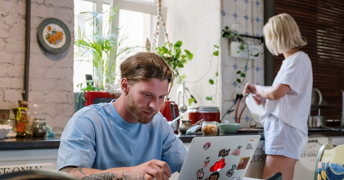 Travellers using a hostel communal kitchen