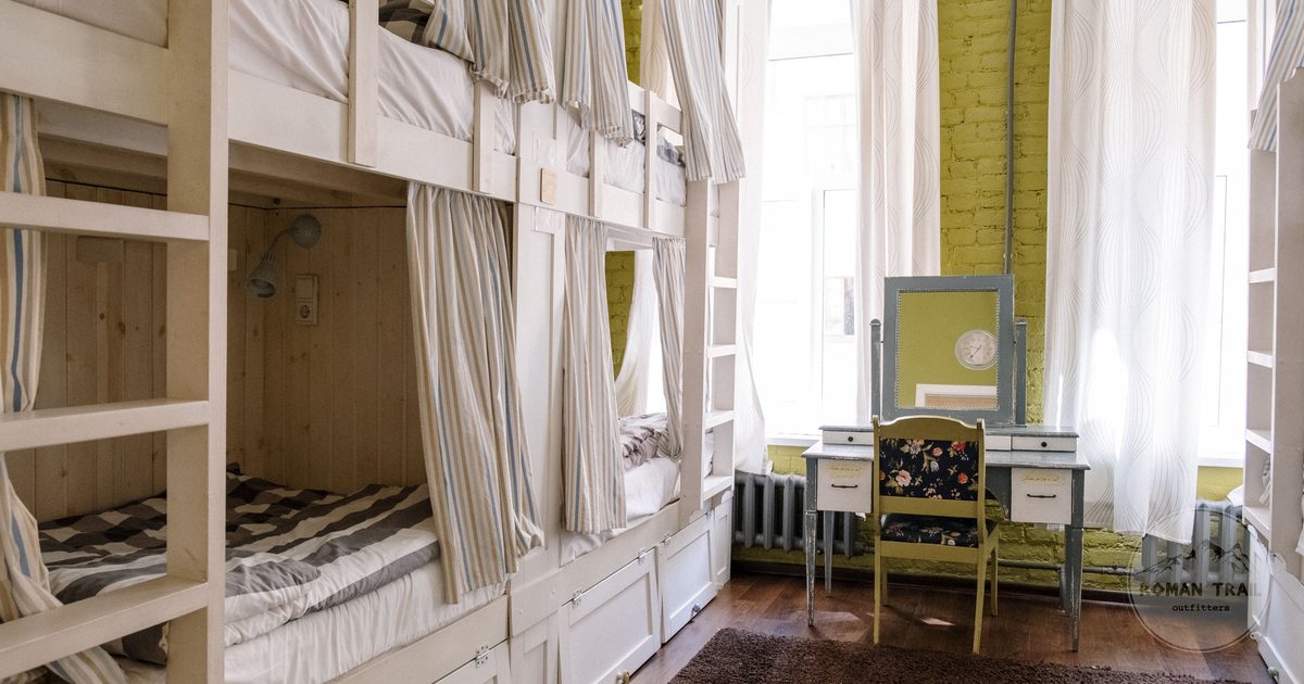A hostel dorm room with clean bunk beds