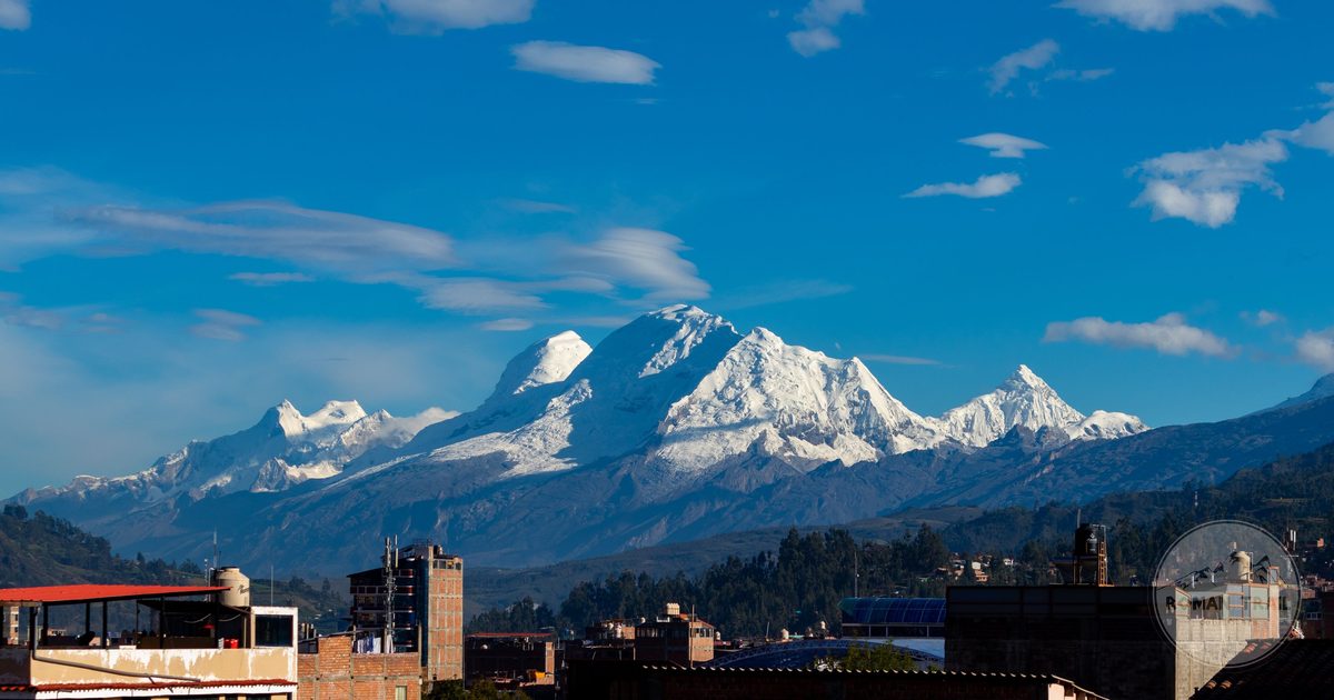 The snow covered Huascaran massif above a Peruvian town, Ancash