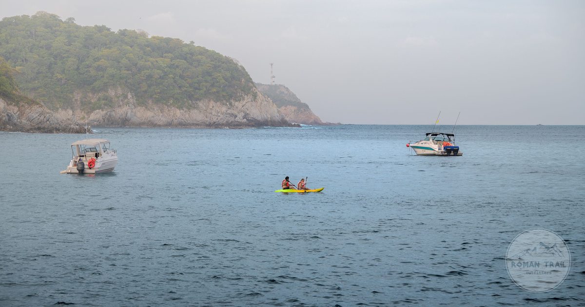Boats and kayakers in a bay at Santa Maria Huatulco, Oaxaca, Mexico