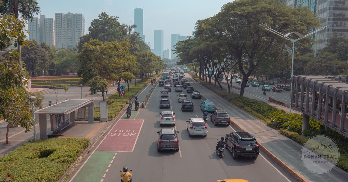 A busy Jakarta road filled with cars, buses and motorbikes, Jakarta packing list for women by Roman Trail Outfitters