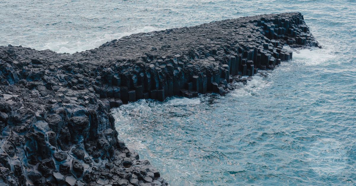 Basalt columns meeting the ocean at Seogwipo on Jeju Island, South Korea