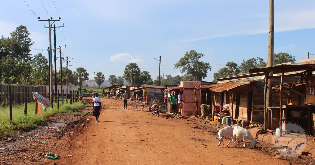 A market street with people and goats in Jinja, Uganda