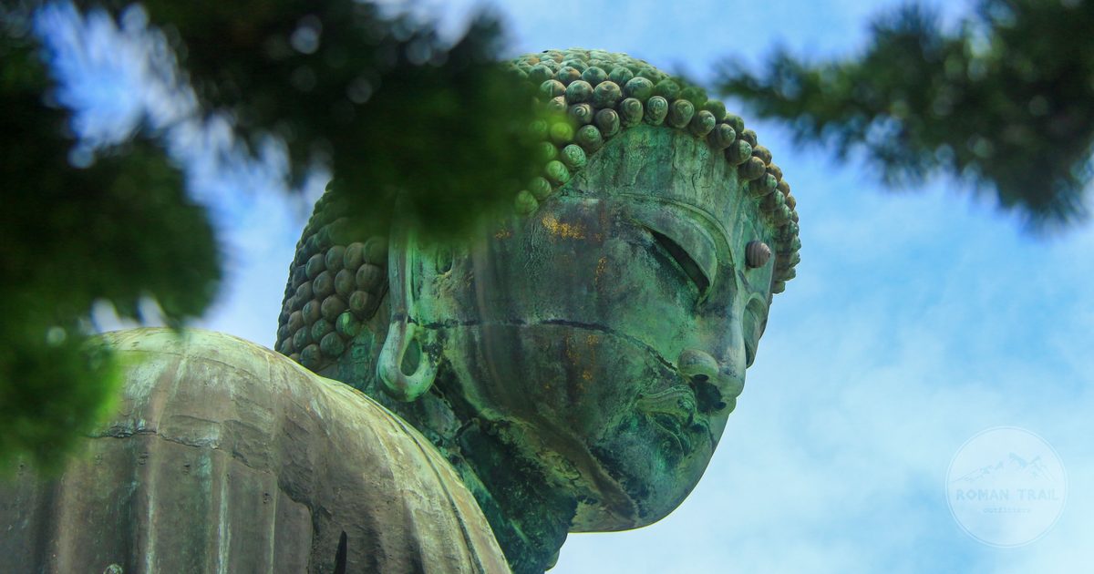 A Buddha statue framed by greenery at Kamakura, Japan