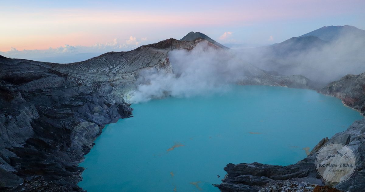 Dawn over the Ijen crater with smoke rising from the turquoise water, East Java, Indonesia