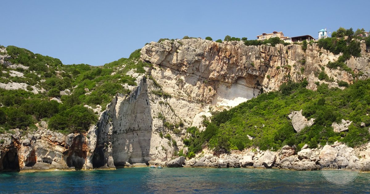 Rocky coastline and clear blue water on a Greek island shore, Kefalonia packing list for women by Roman Trail Outfitters