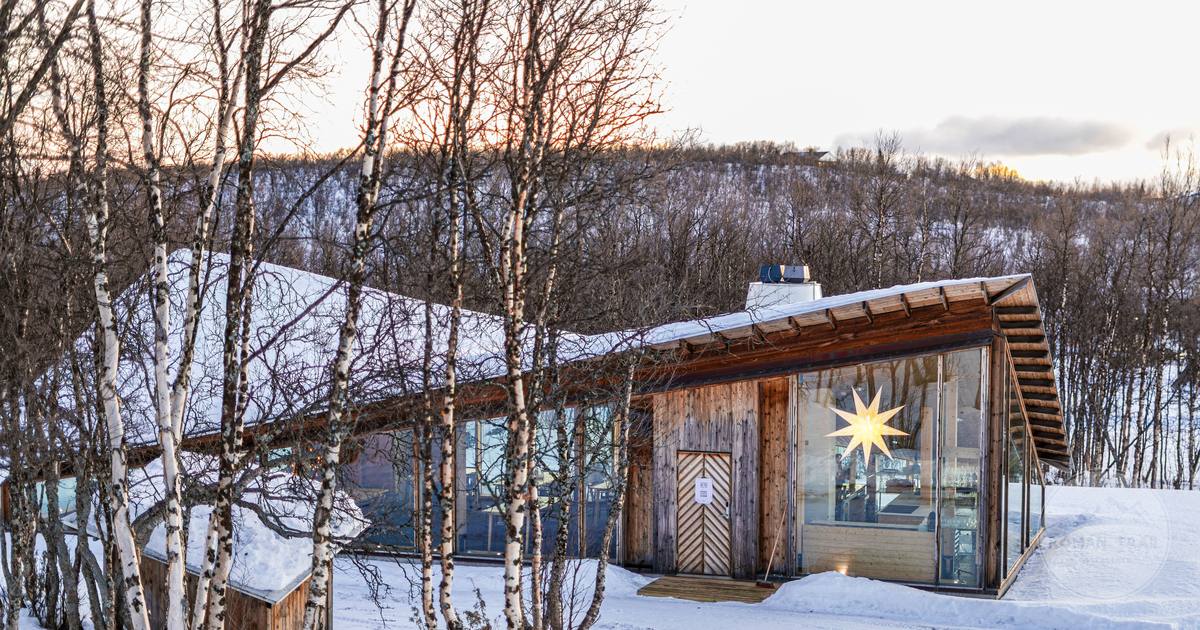A wooden cottage in the snow at sunset in Kiruna, Sweden