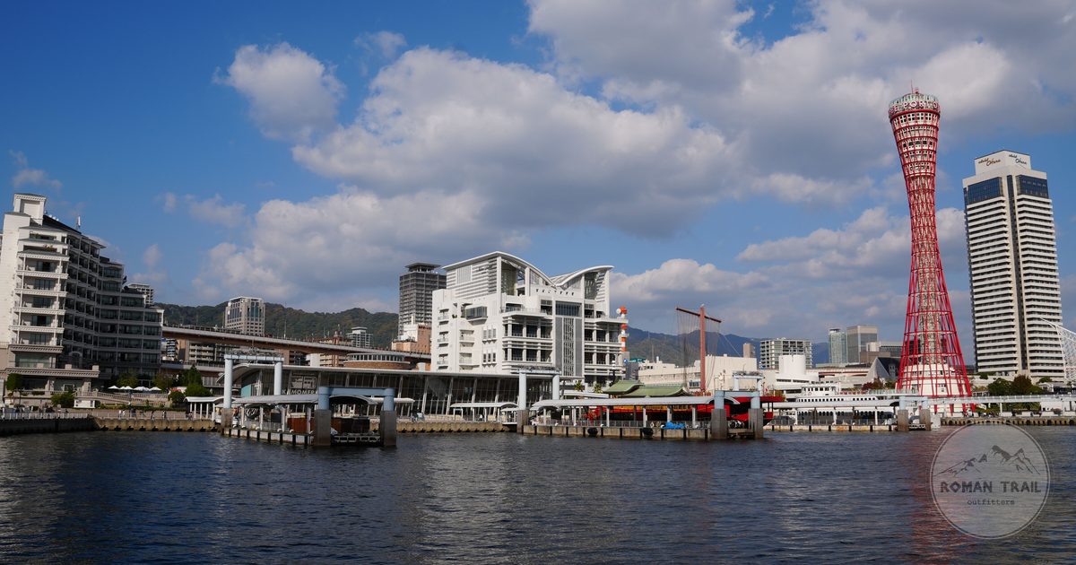 The red Kobe Port Tower on the waterfront under a blue sky, Japan