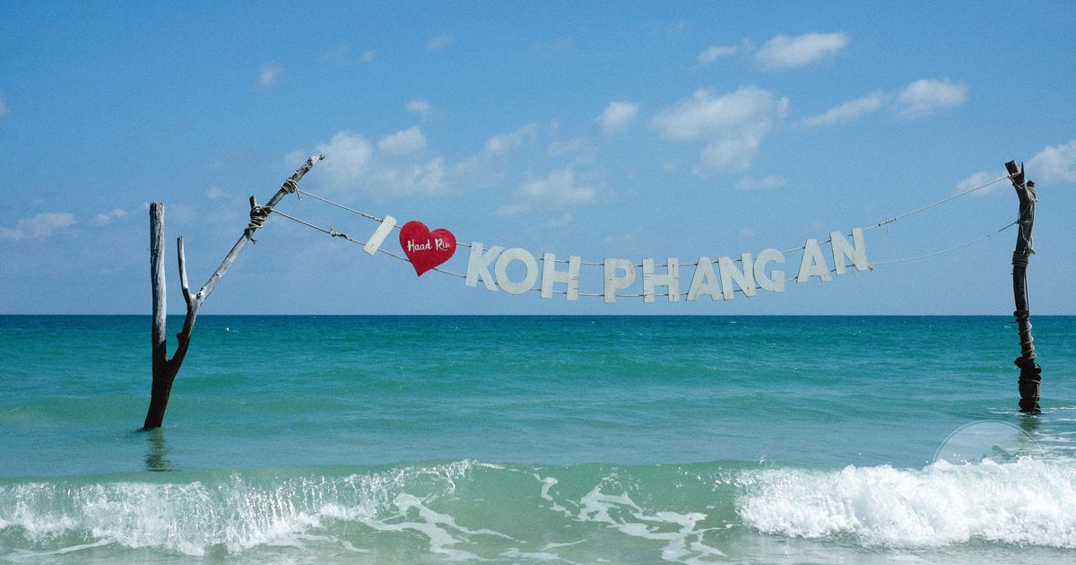 Waves and a welcome sign on the shore at Koh Phangan, Thailand
