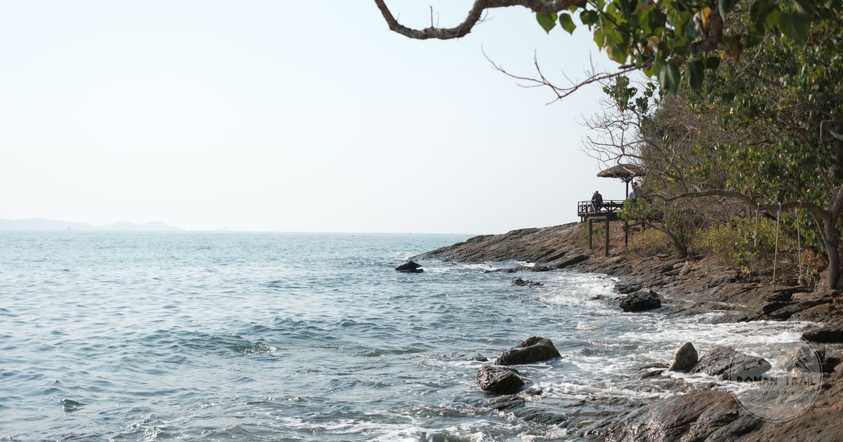 Calm waves on the rocky shore at Phe Beach, Rayong, Thailand