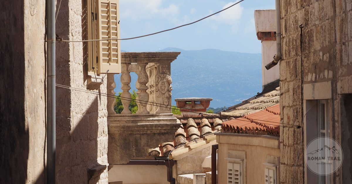 A narrow stone alley and tiled rooftops in Korcula, Croatia