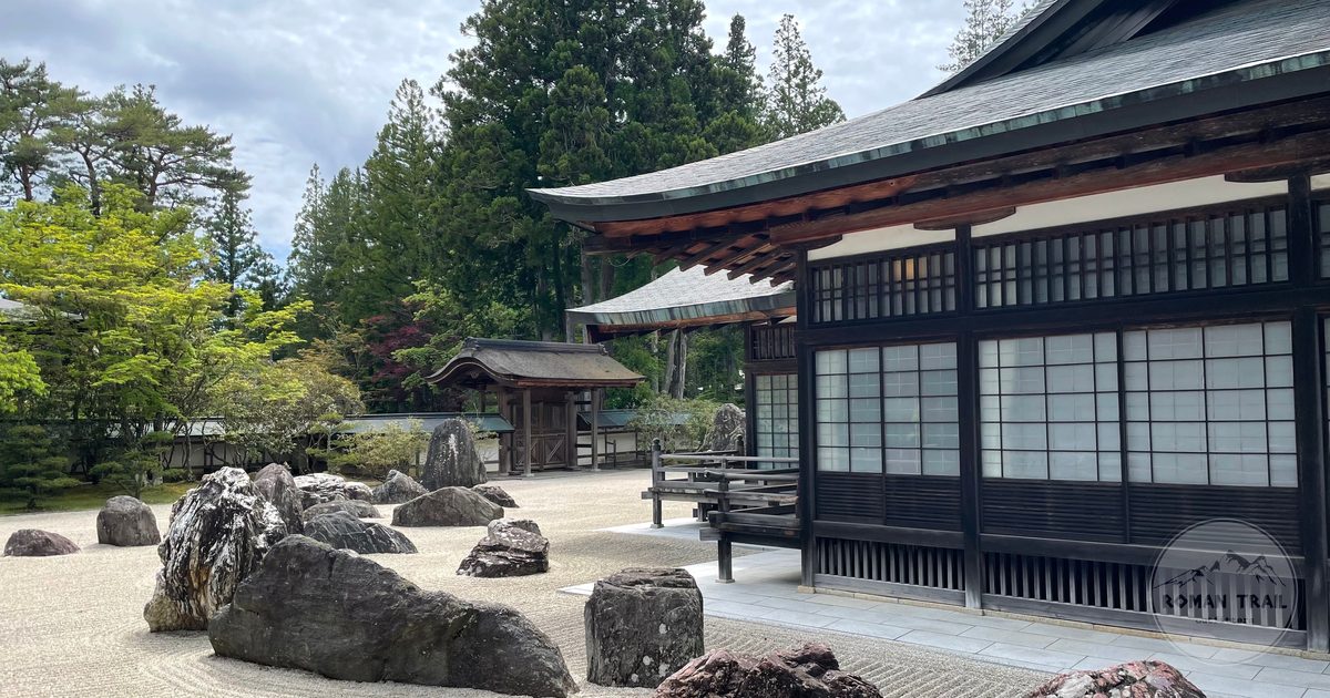 A traditional Japanese rock garden beside temple buildings