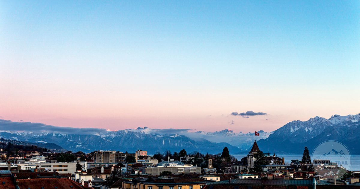Lausanne at sunset with Lake Geneva and the Alps beyond, Lausanne packing list for women by Roman Trail Outfitters