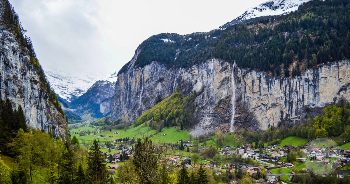 Lauterbrunnen village on grassland below the alpine walls, Switzerland