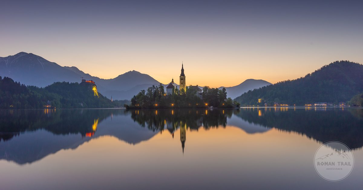 Lake Bled and its island church reflected at dawn, Ljubljana travel guide for women by Roman Trail Outfitters