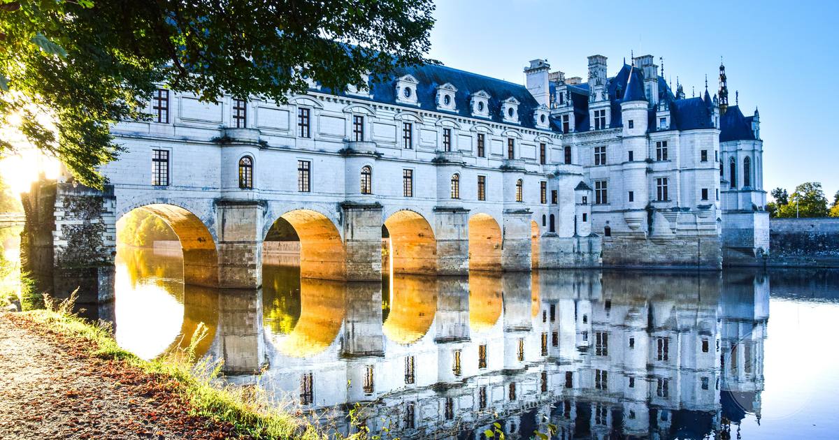 The Chateau de Chenonceau reflected in the river Cher at sunrise, France