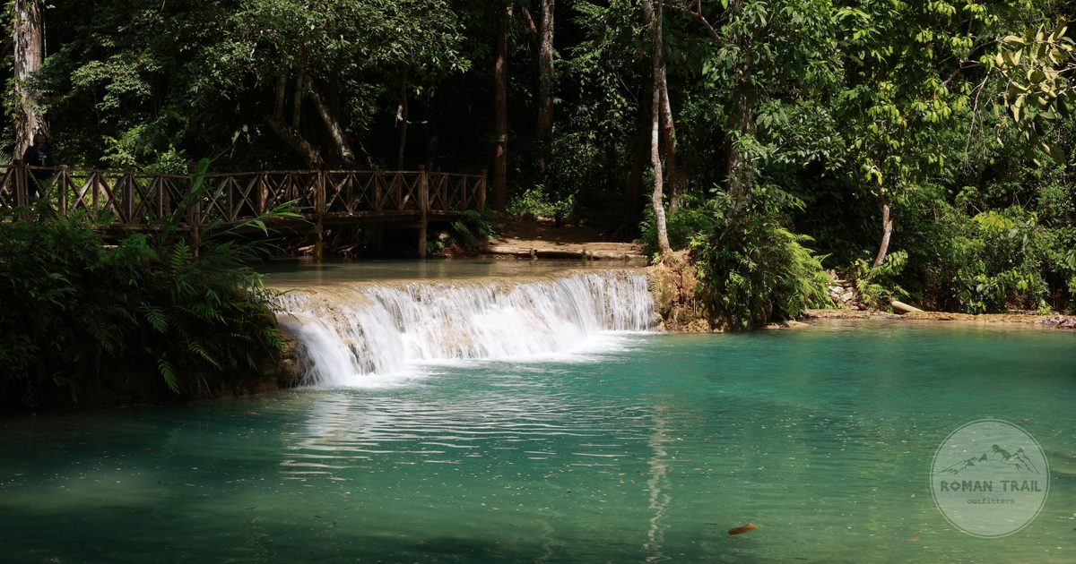Turquoise travertine pools at Kuang Si Falls in the forest near Luang Prabang, Laos for women travelers
