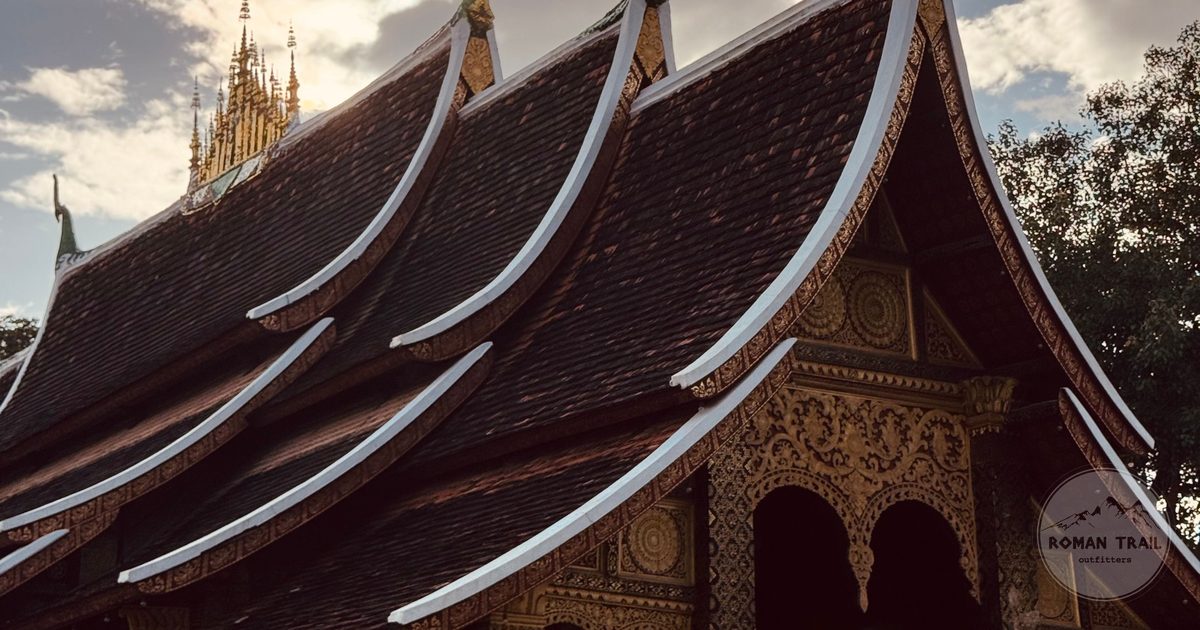 The sweeping tiered roof of Wat Xieng Thong at sunset, Luang Prabang for women travelers