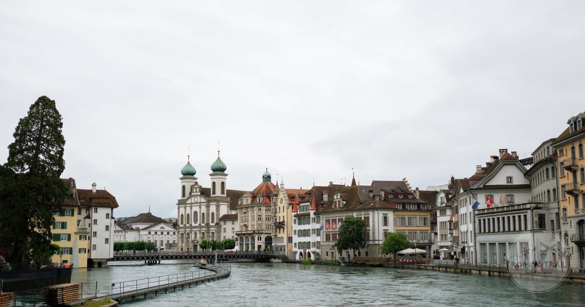 Lucerne old town along the Reuss river with the mountains behind, Lucerne packing list for women by Roman Trail Outfitters