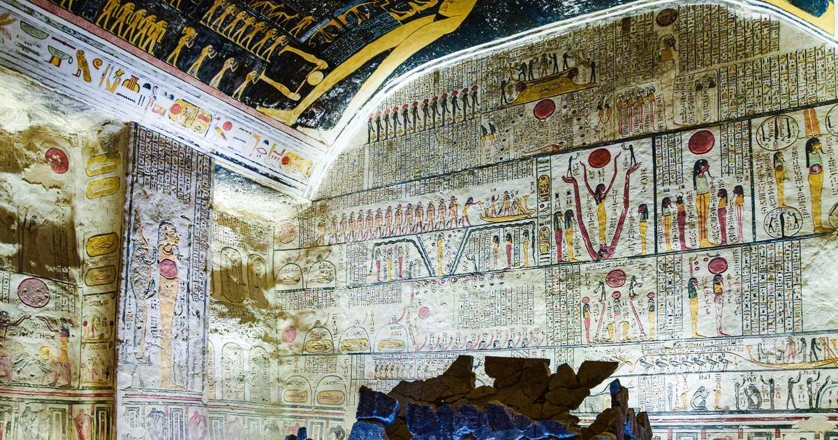 Brightly painted frescoes and hieroglyphs inside an ancient Egyptian tomb at Luxor, Luxor packing list for women by Roman Trail Outfitters