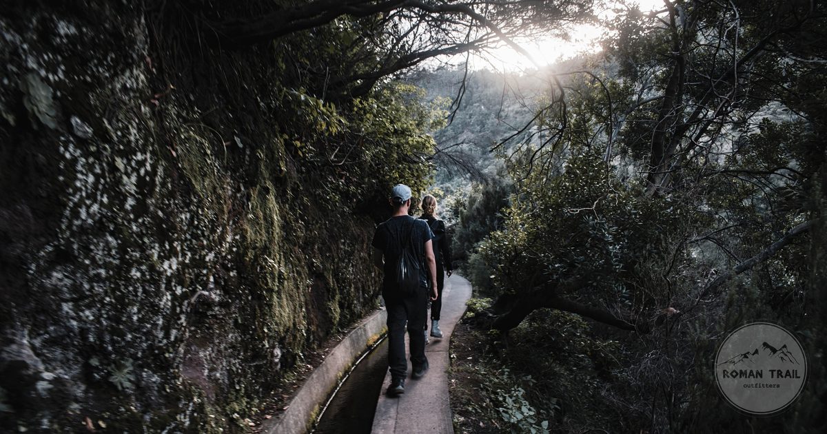 Hikers on a levada trail through laurel forest in Madeira, Portugal