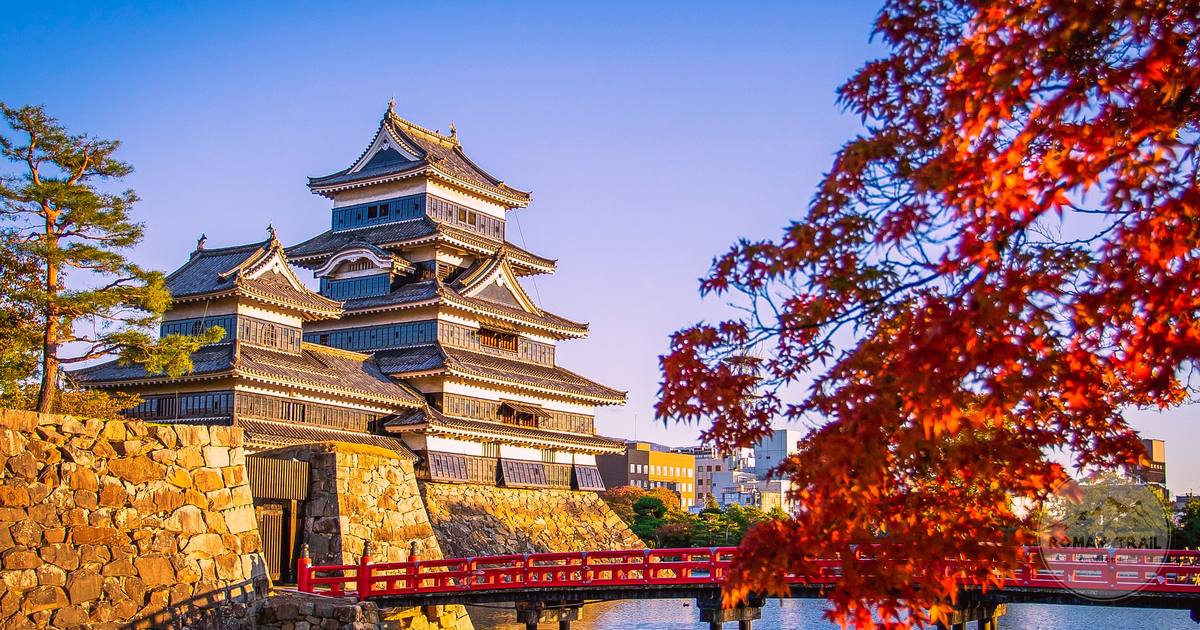 Matsumoto Castle and the red bridge in autumn foliage, Japan