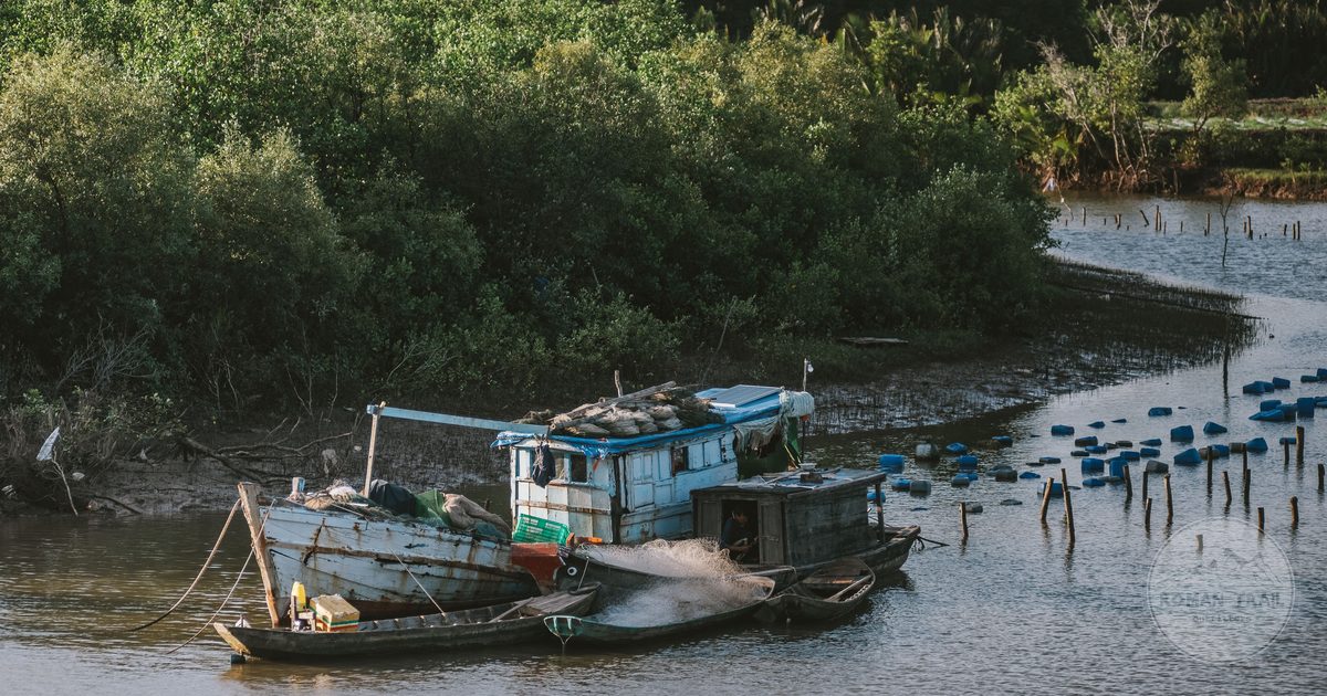 Fishing boats moored on a river at Ben Tre, Vietnam