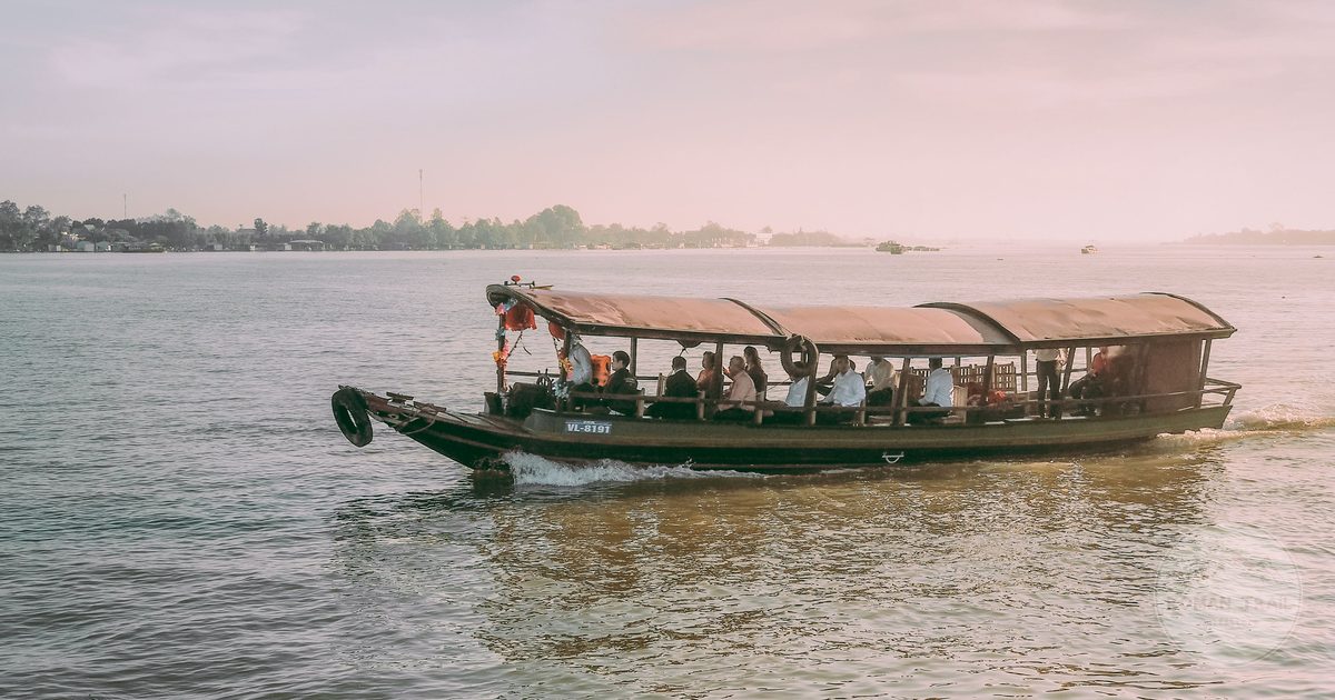 A wooden boat on the Mekong at sunset, Vinh Long, Vietnam