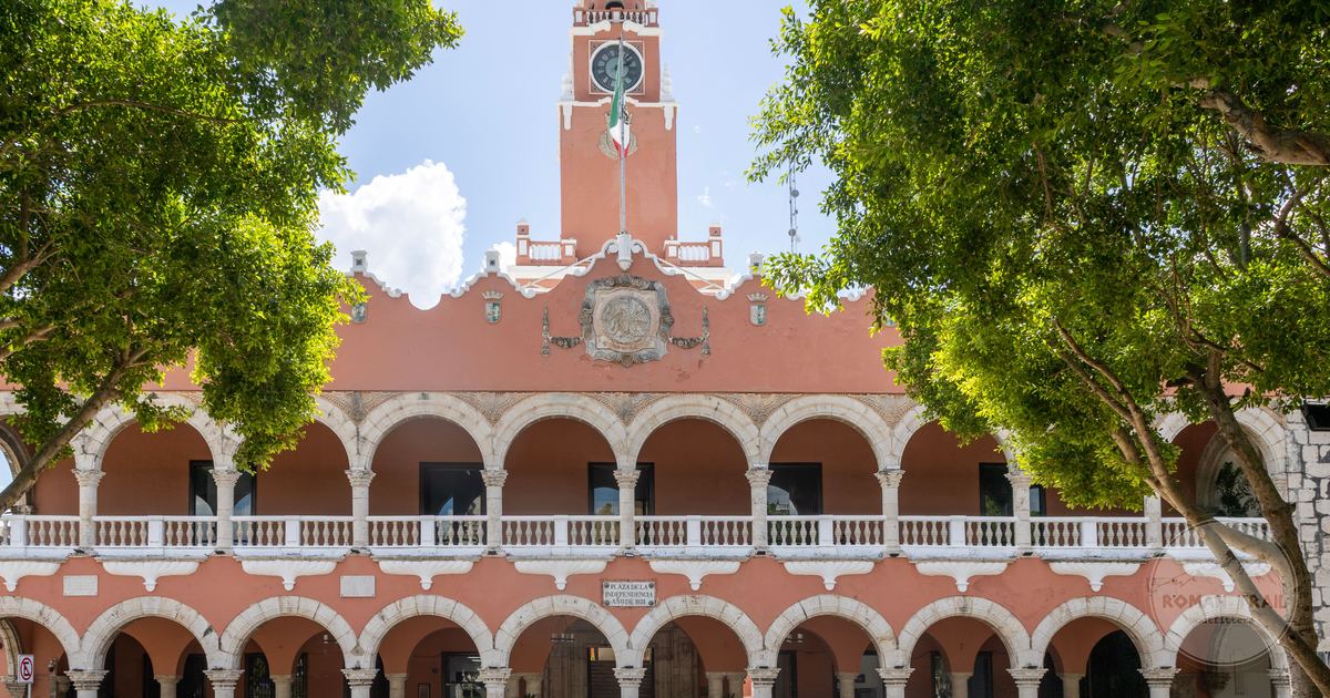 A colonial building with arches and a clock tower in Merida, Yucatan, Mexico