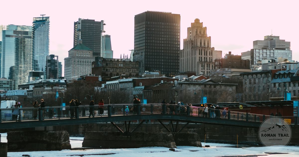 Footbridge over the frozen Old Port with the Montreal skyline behind in winter light, Montreal for women travelers