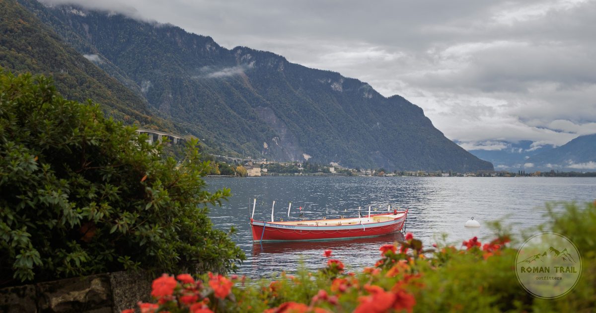 A red boat on Lake Geneva at Montreux with the Alps behind, Switzerland