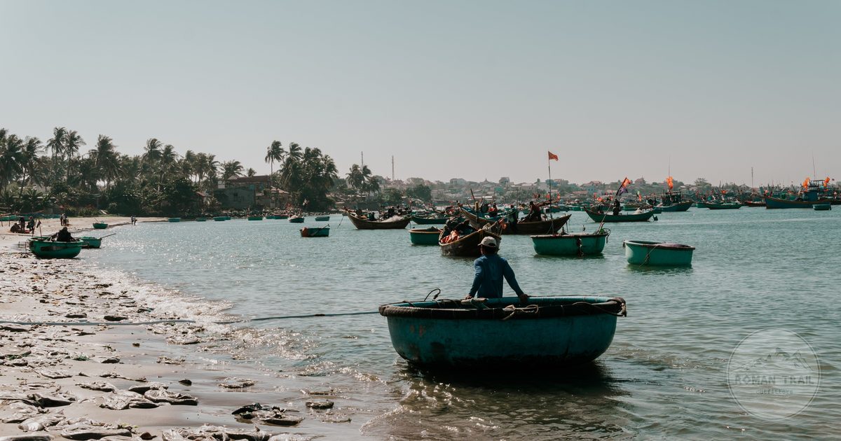 A fisherman on a round basket boat at Mui Ne Beach, Vietnam
