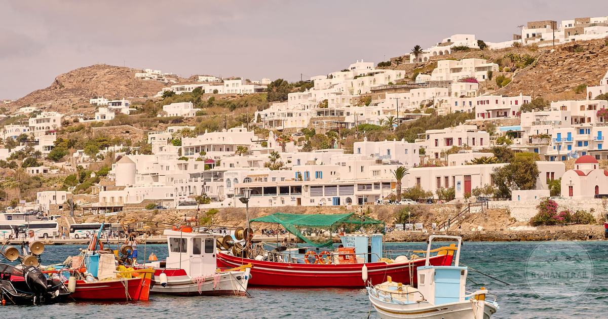 White buildings and fishing boats in Mykonos harbour, Greece