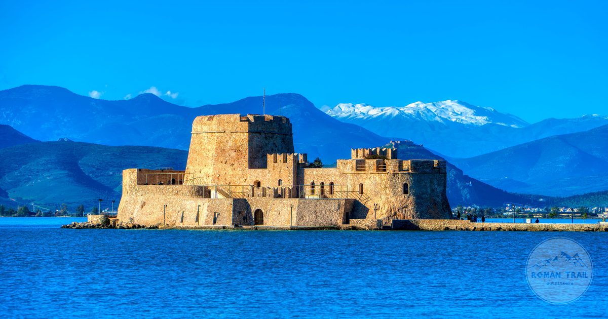 Bourtzi Castle in the bay at Nafplio with mountains behind, Greece