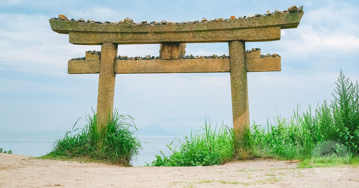 A stone torii gate on a beach at Naoshima, Kagawa, Japan