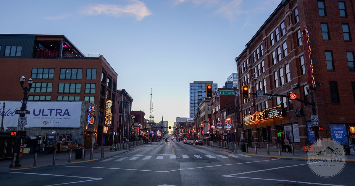 Lower Broadway at dusk with honky tonk signs lighting the street, Nashville for women travelers