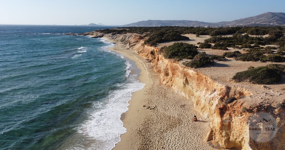 Aerial view of a Naxos beach with rocky cliffs and clear sea, Greece