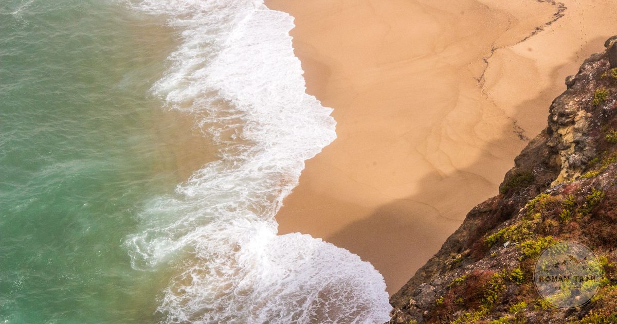 Heavy Atlantic waves breaking on the shore at Nazare, Nazare packing list for women by Roman Trail Outfitters