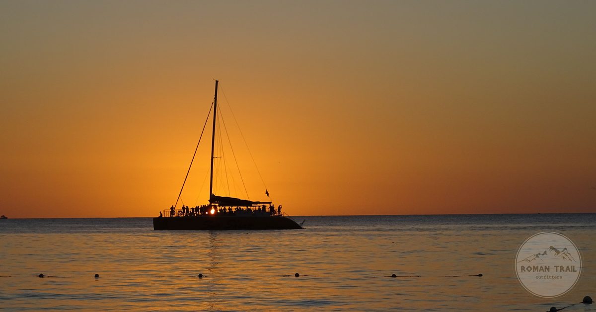 A boat silhouetted against the sunset at Negril, Jamaica