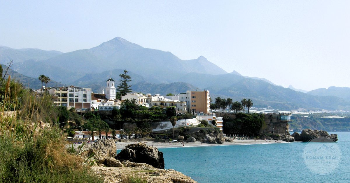 The coastal town of Nerja with mountains behind and clear sea, Spain