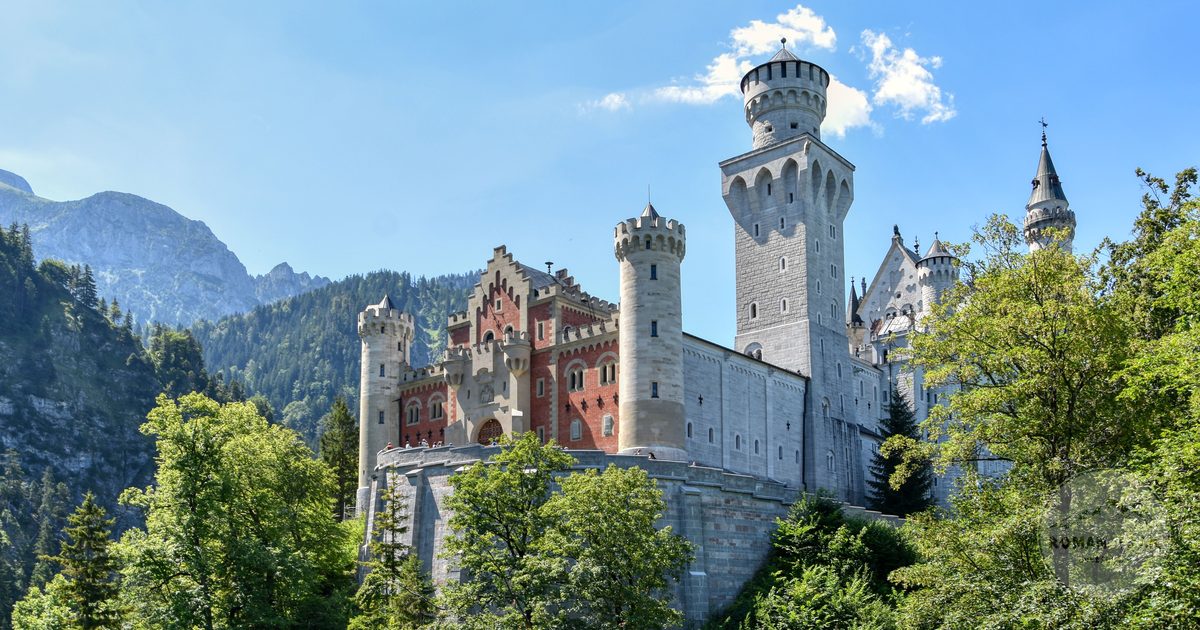 Neuschwanstein Castle surrounded by Bavarian countryside in summer, Germany