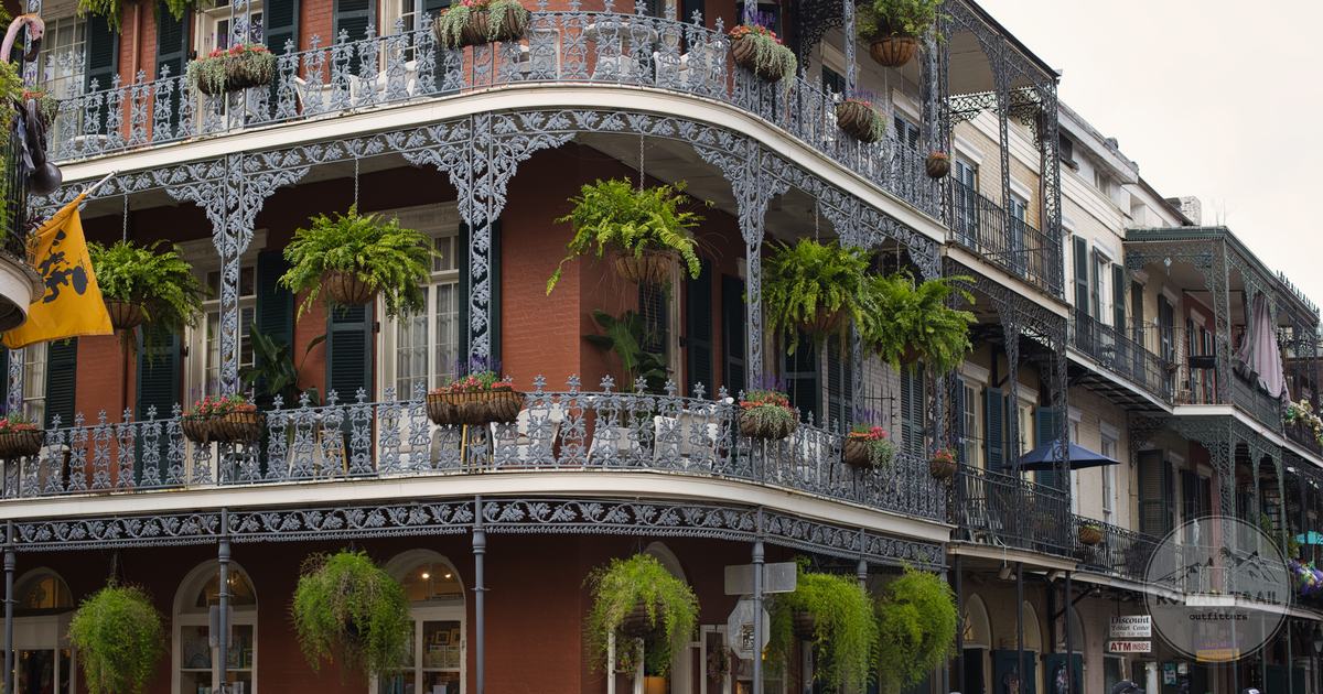 Wrought iron balconies with hanging ferns on a French Quarter building, New Orleans for women travelers