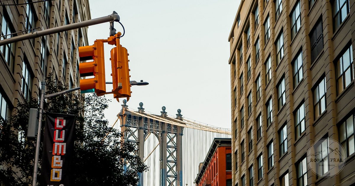 Manhattan Bridge framed by brick buildings on Washington Street in DUMBO Brooklyn, New York City for women travelers