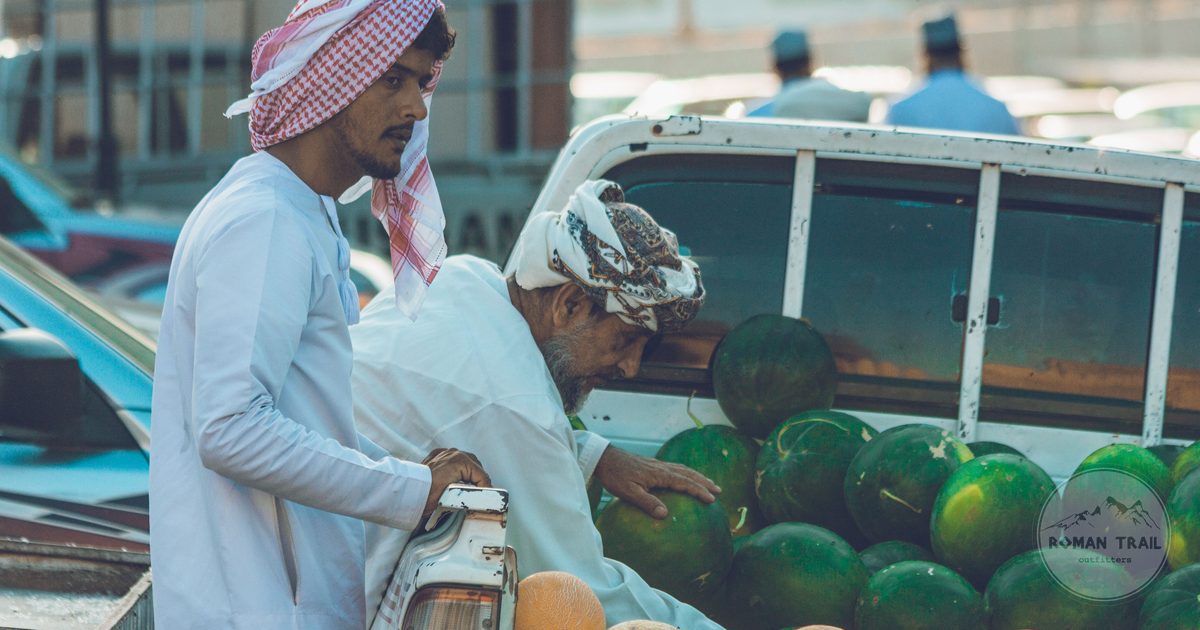 Two men selling watermelons and melons from a truck at the market in Nizwa, Oman