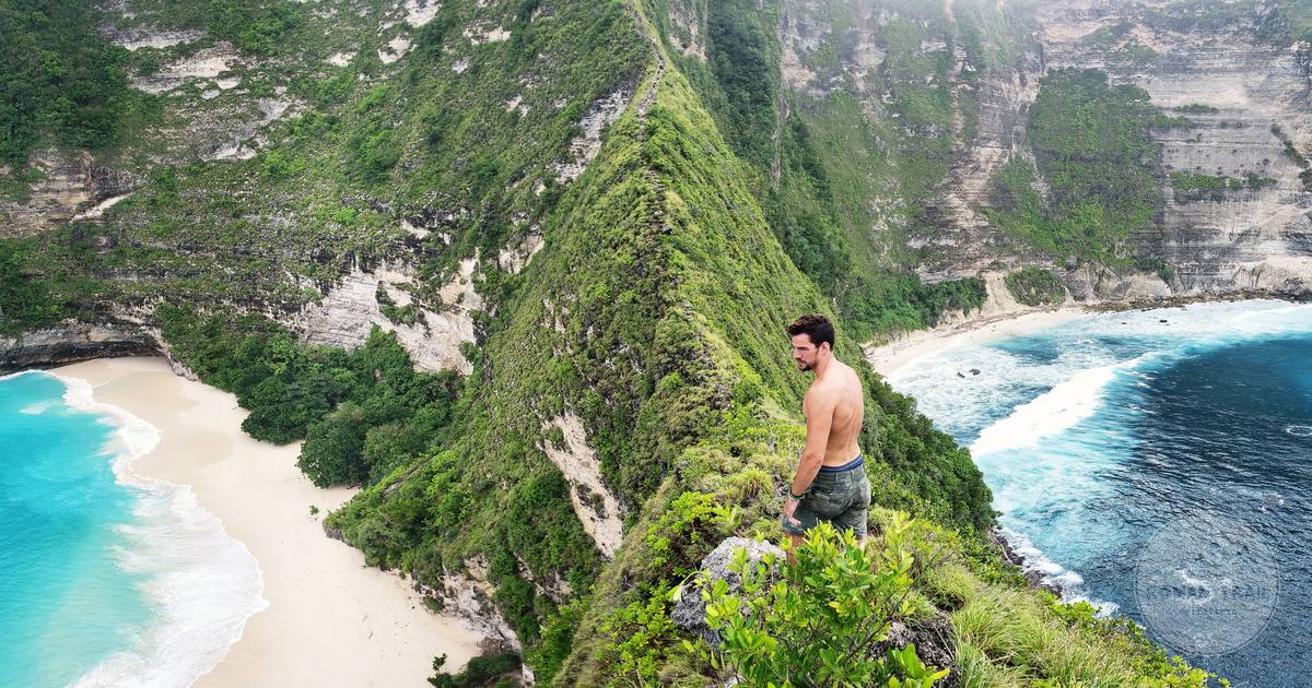 A person on the steep cliff path at Kelingking Beach, Nusa Penida, Indonesia