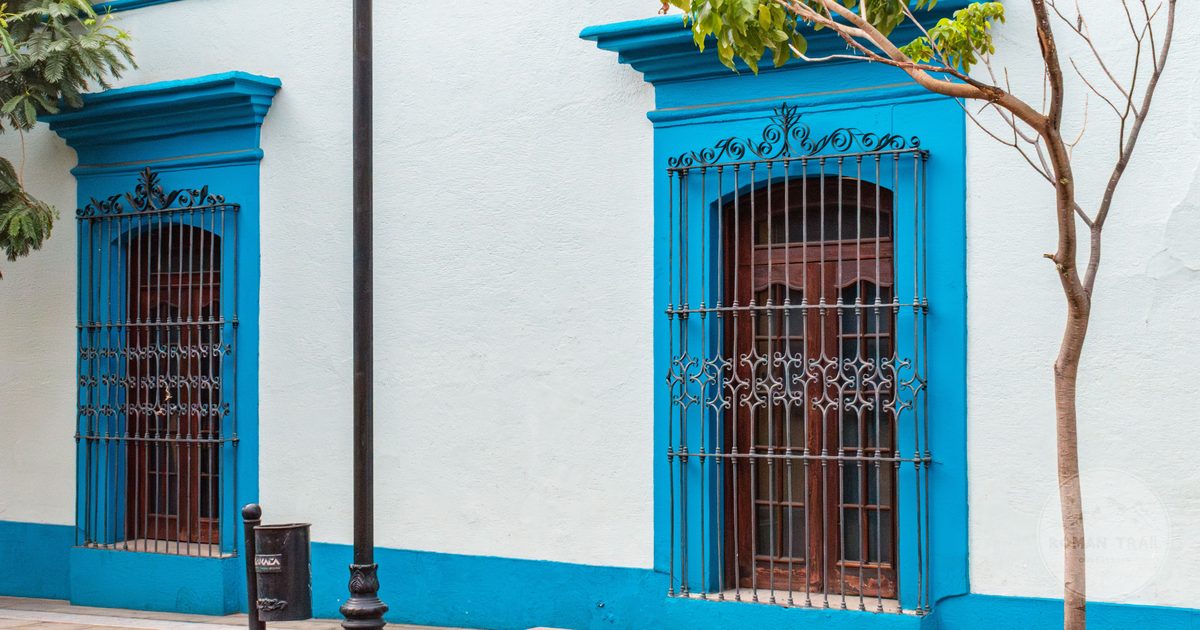 A colourful colonial facade with wrought iron windows in Oaxaca, Mexico