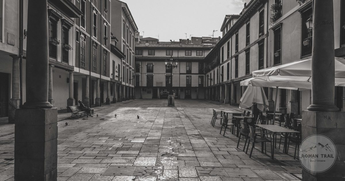 A historic square with empty cafe tables in Oviedo, Spain